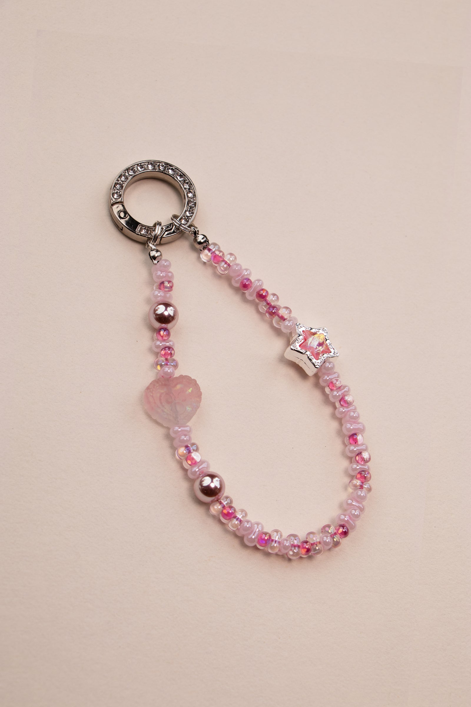 Blush Star beaded phone charm attached to phone with included tether tab