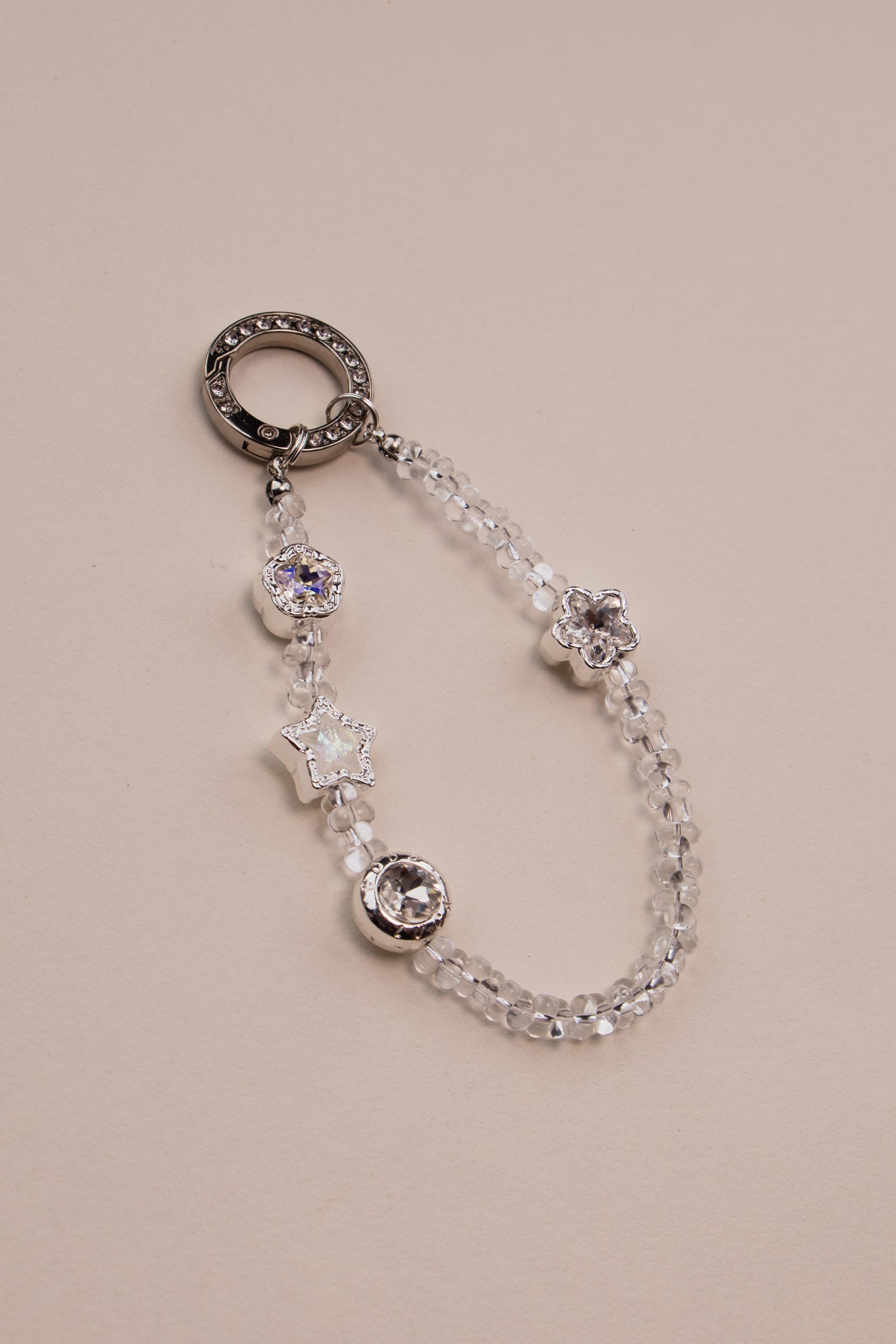 Crystal star beaded phone charm with silver rhinestone ring on white background