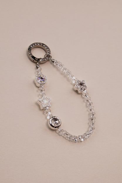 Crystal star beaded phone charm with silver rhinestone ring on white background