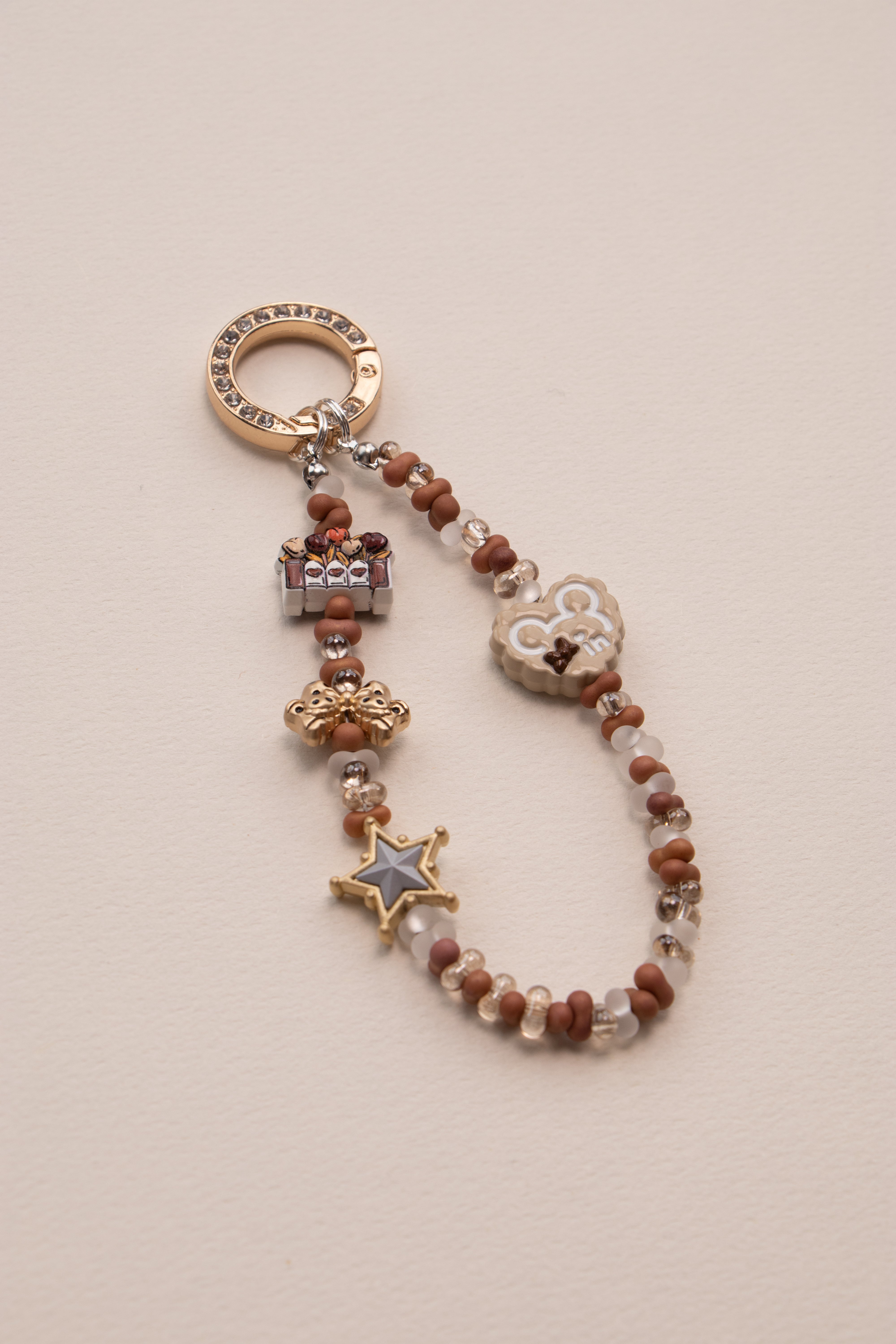 Little Luck beaded phone charm attached to phone with tether tab