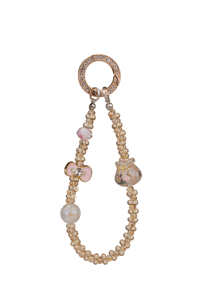 Golden Bloom phone charm with pink bow and gold-tone ring on white background