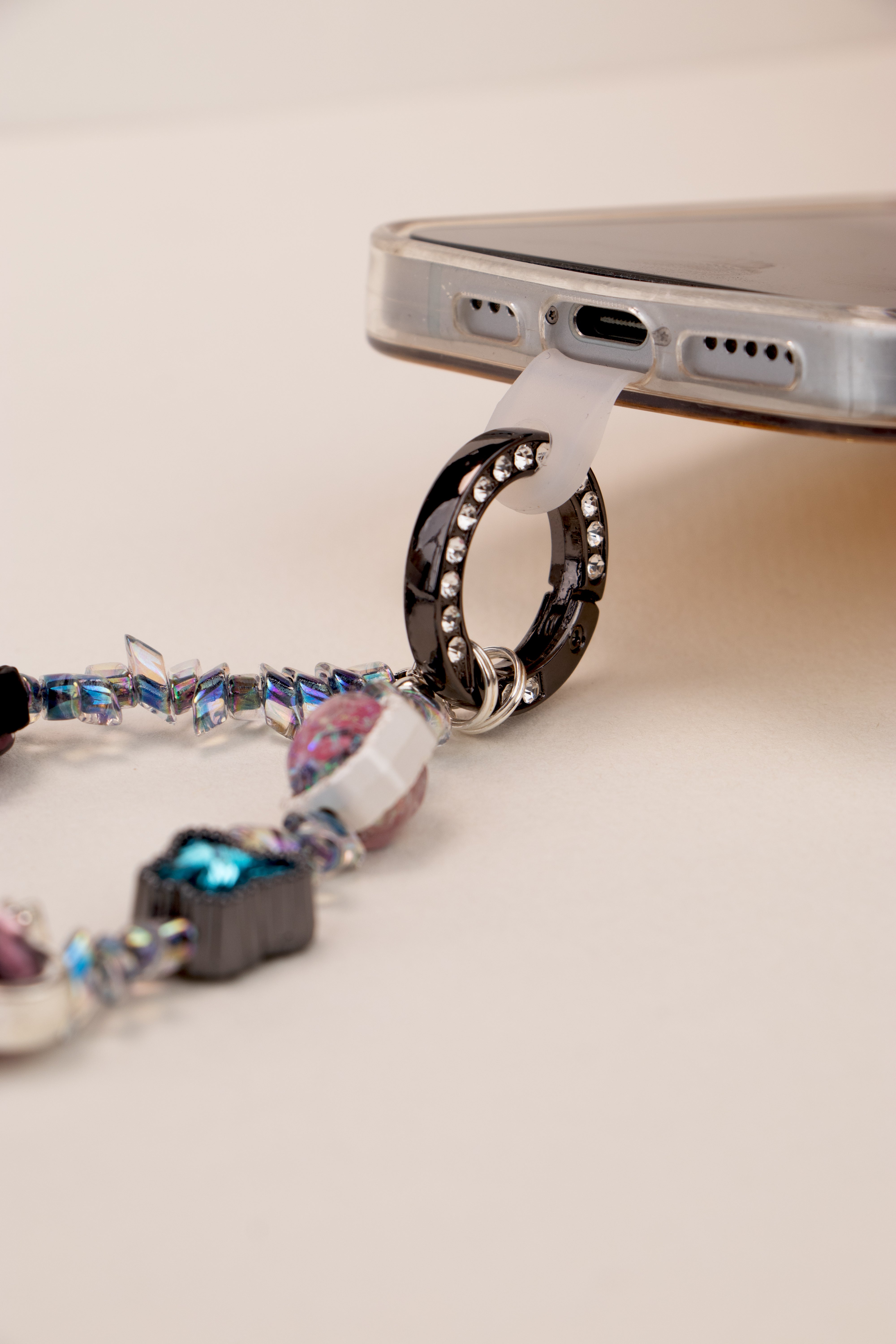 Phone tether tab attached to Blue Ribbon phone charm on phone case