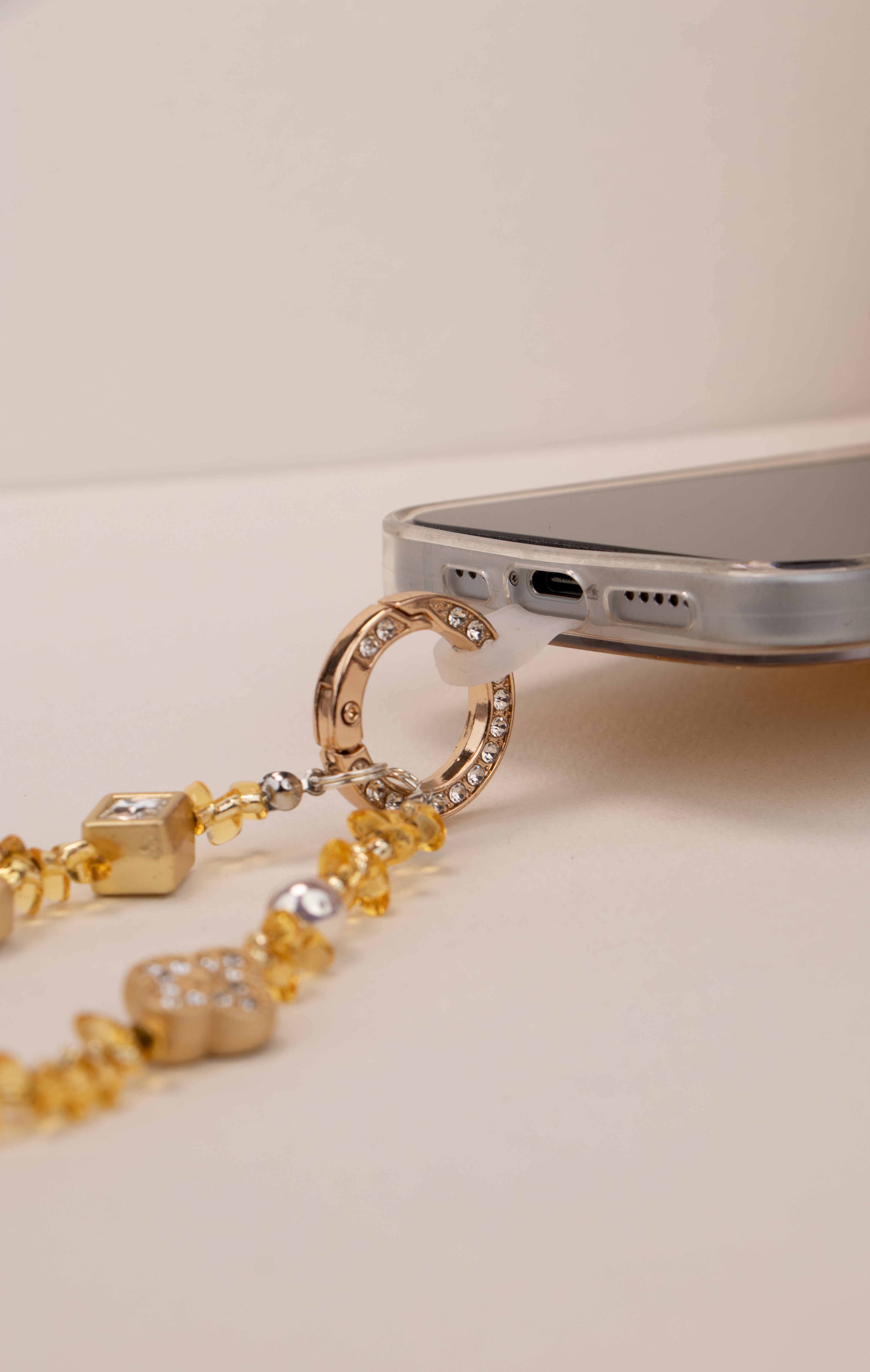 Phone tether tab attached to Honey Light phone charm on phone case