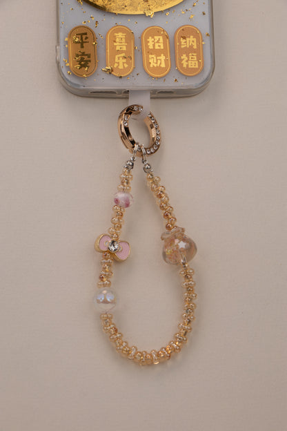 Golden Bloom beaded phone charm attached to phone with included tether tab