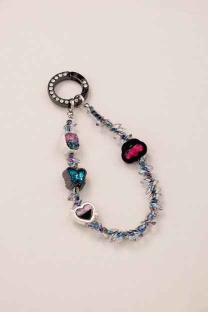 Midnight Flutter beaded phone charm with dark iridescent beads on phone case