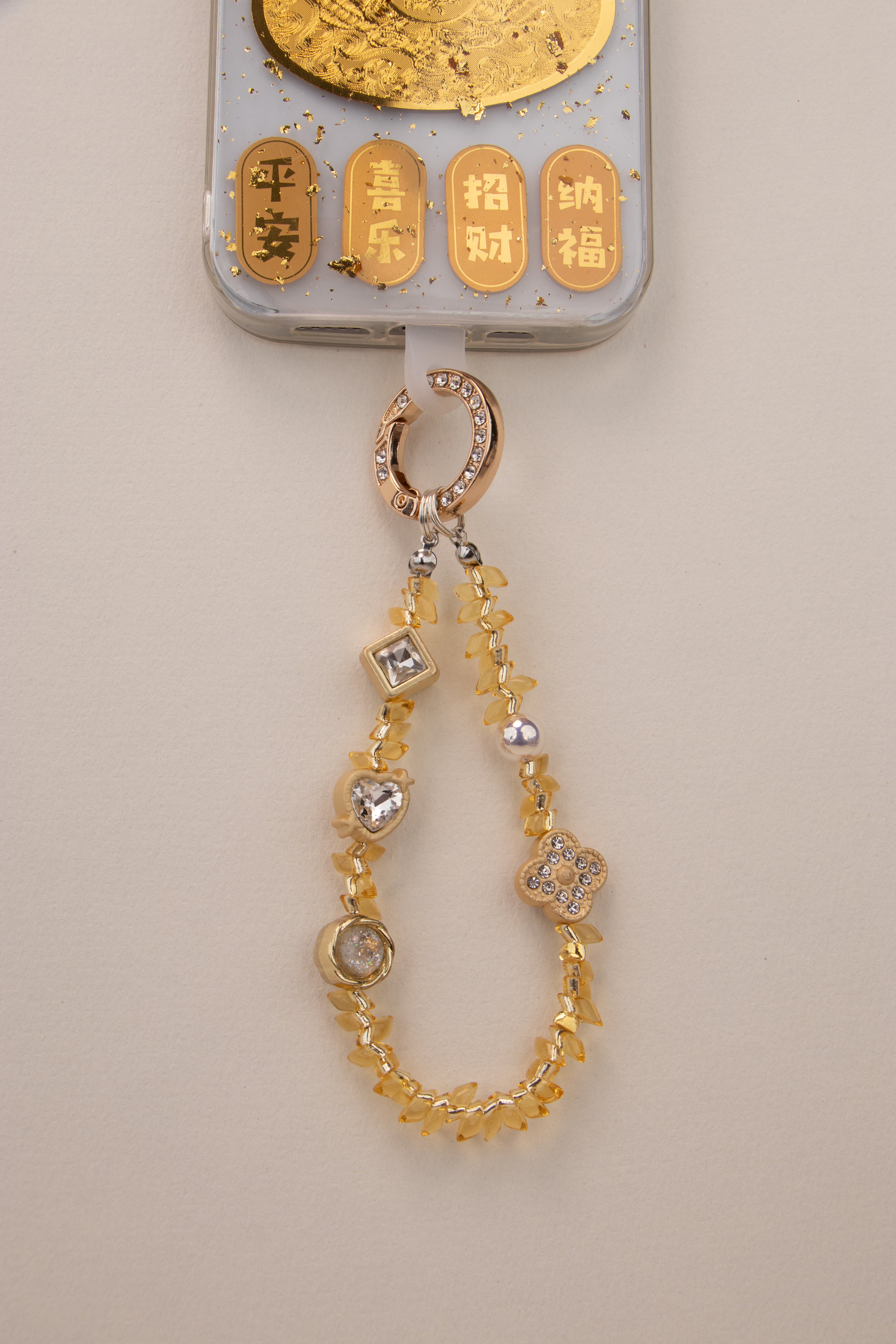 Honey Light beaded phone charm attached to phone with included tether tab