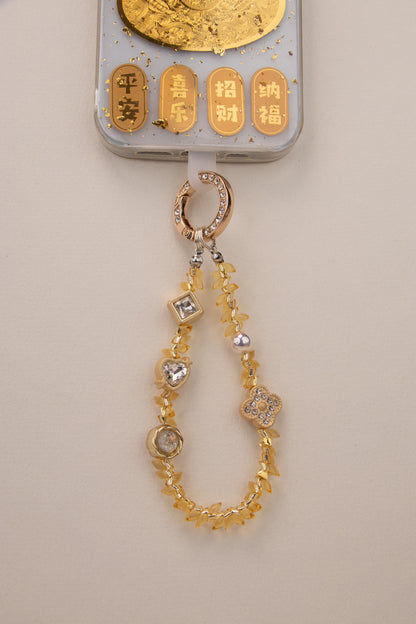 Honey Light beaded phone charm attached to phone with included tether tab