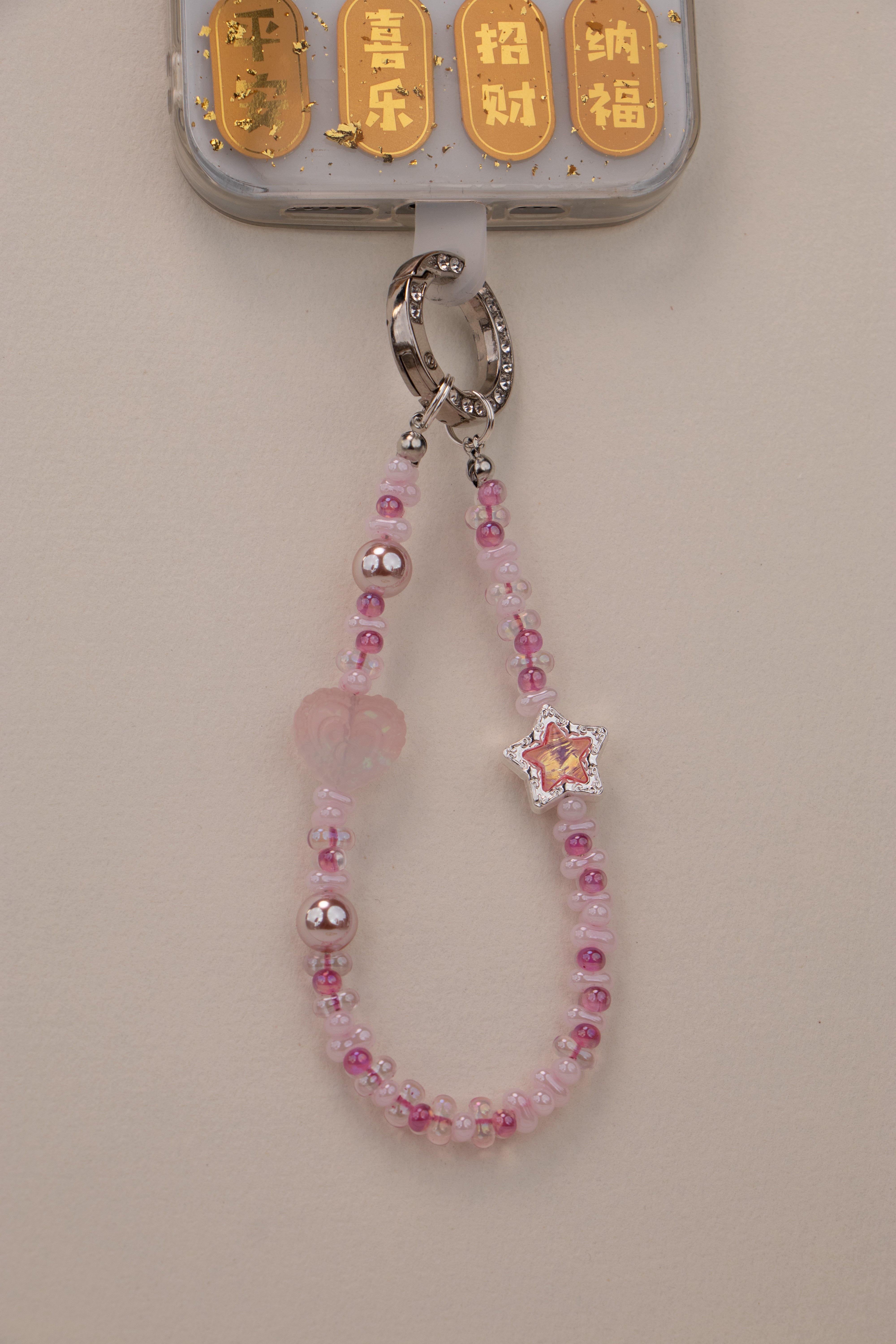 Blush Star beaded phone charm with blush pink beads on neutral background