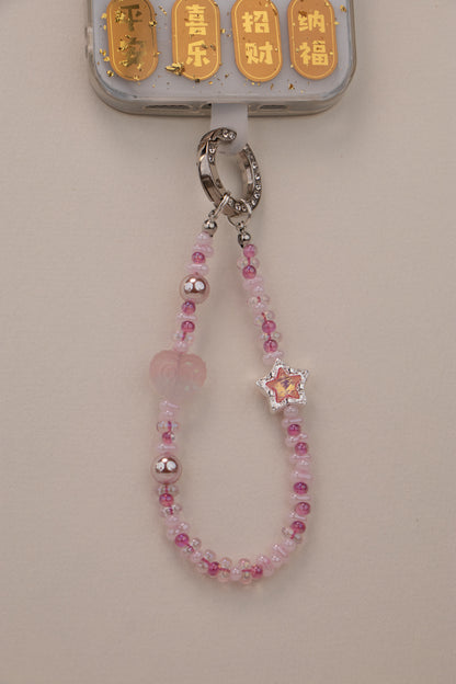 Blush Star beaded phone charm with blush pink beads on neutral background