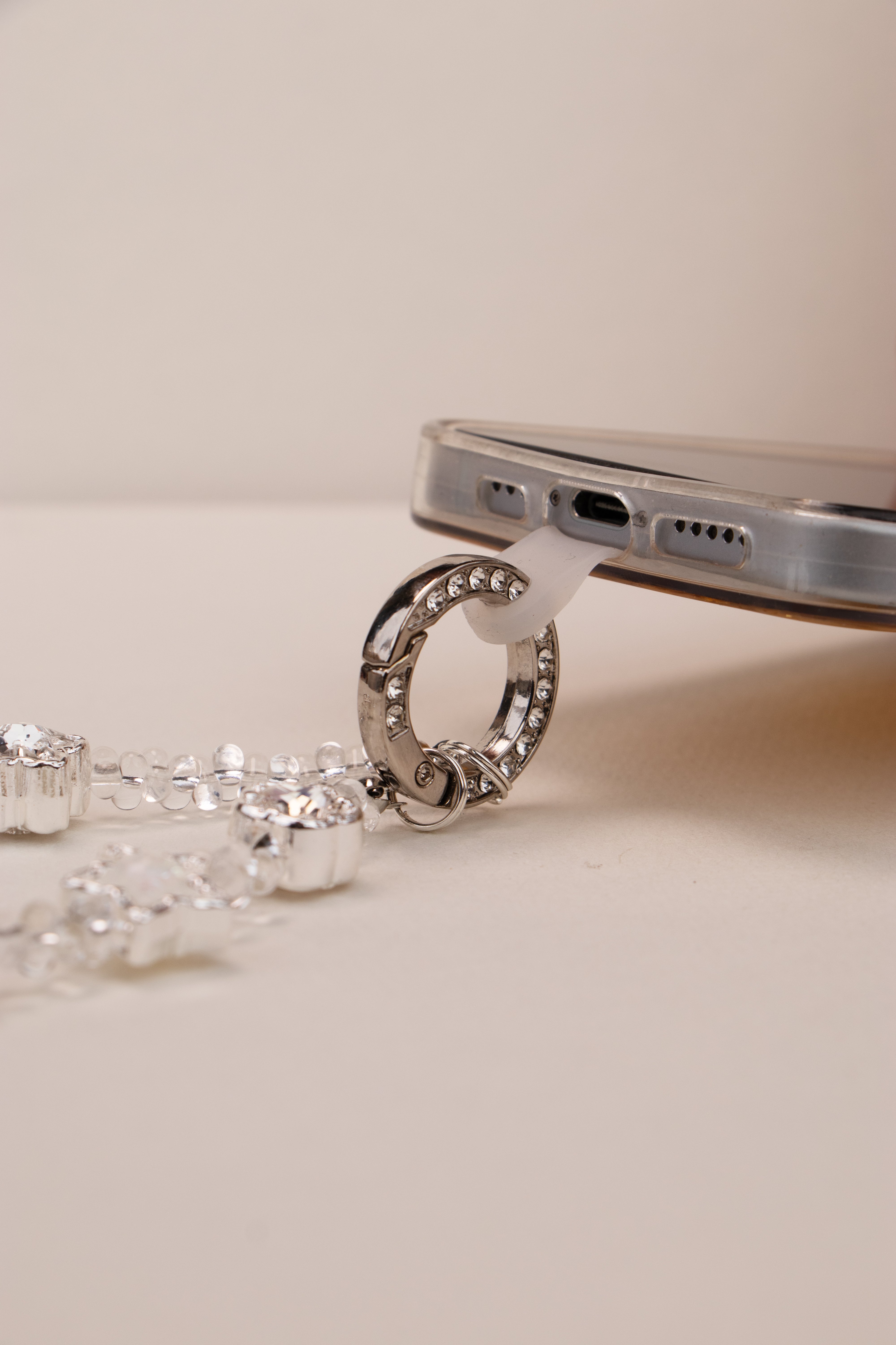 Phone tether tab attached to silver ring on phone case