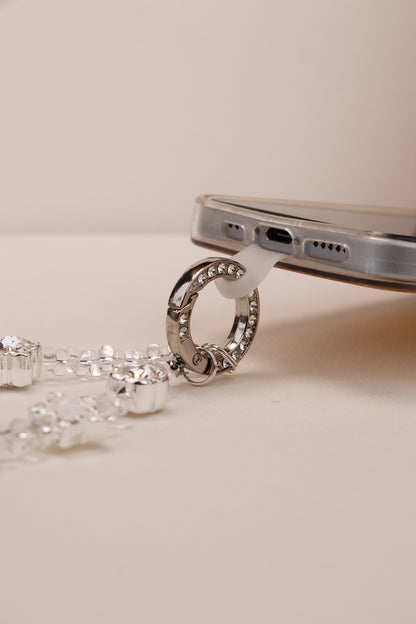 Phone tether tab attached to silver ring on phone case