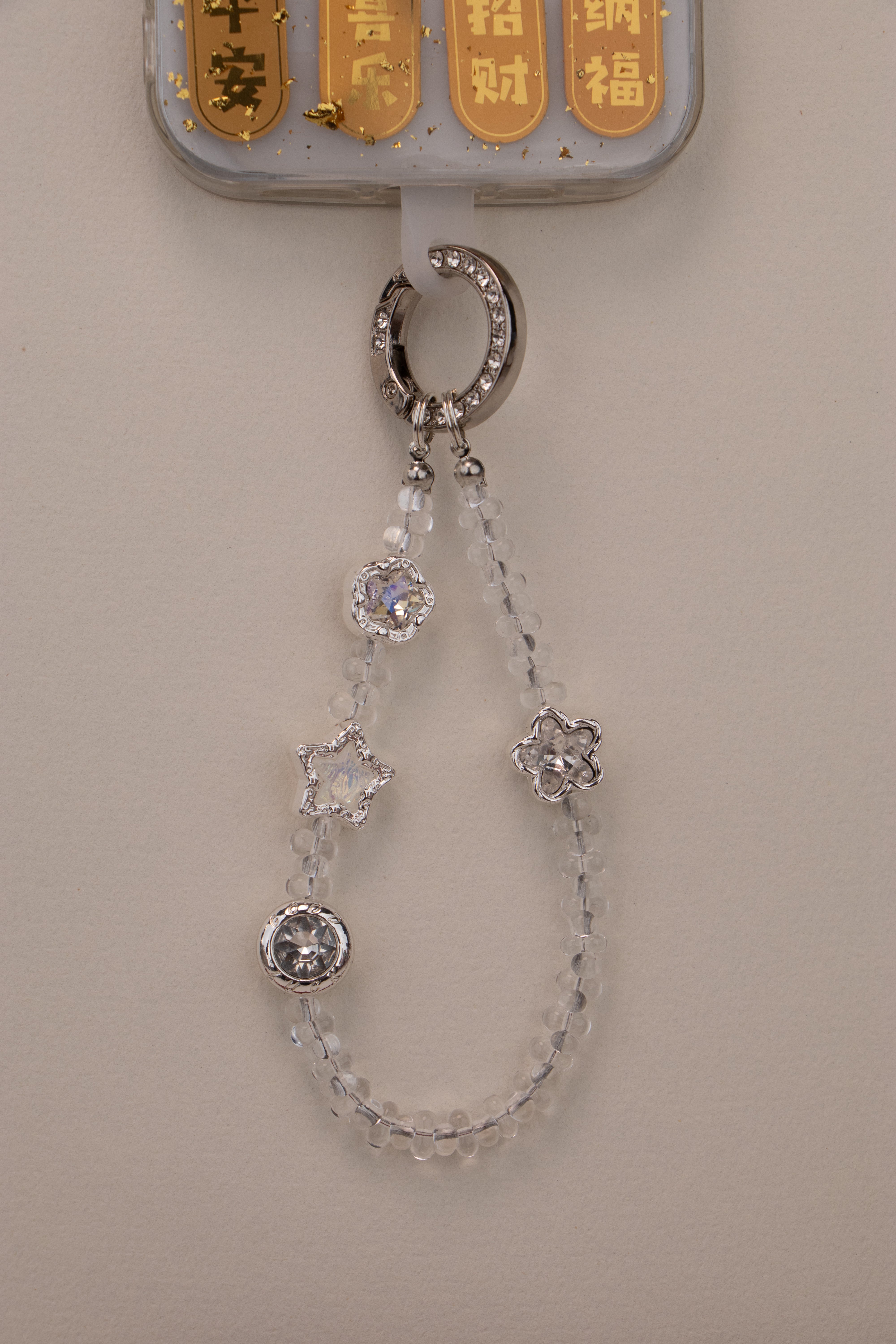 Quiet Star phone charm attached to phone with included tether tab